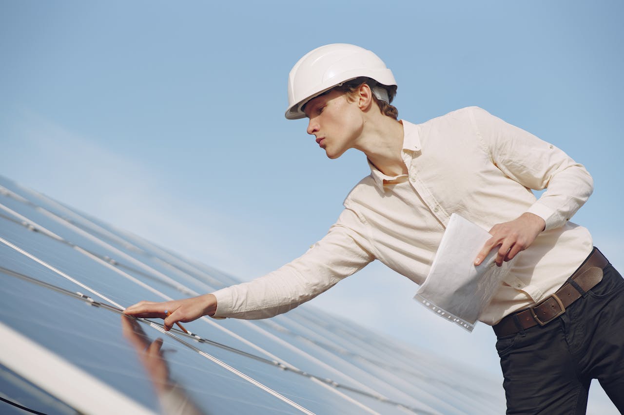 Solar Technician Inspecting Solar Panel